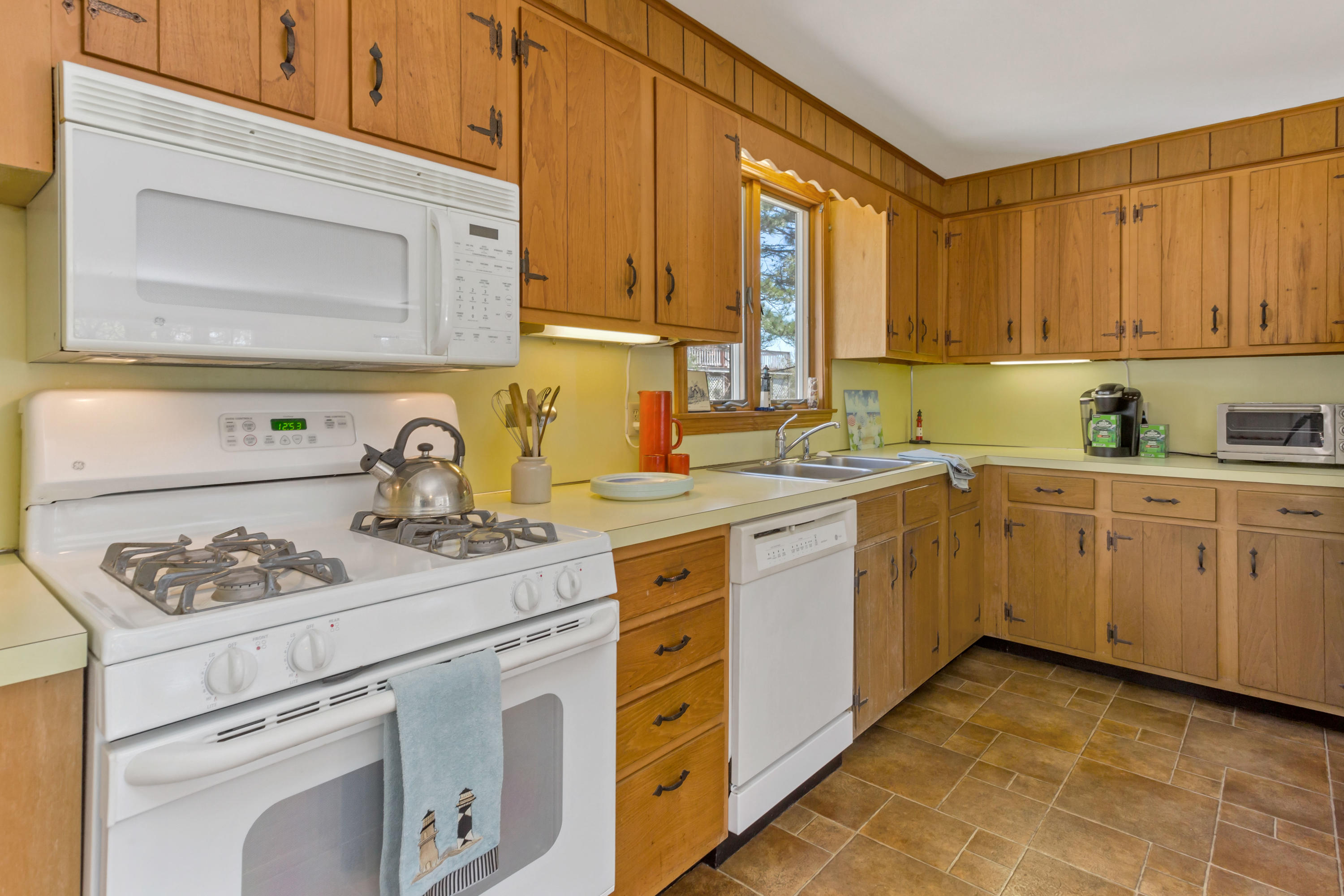 140 Salt Works Road Eastham, MA 02642 - Photo 16 of 49 a kitchen with cabinets appliances a sink and a window