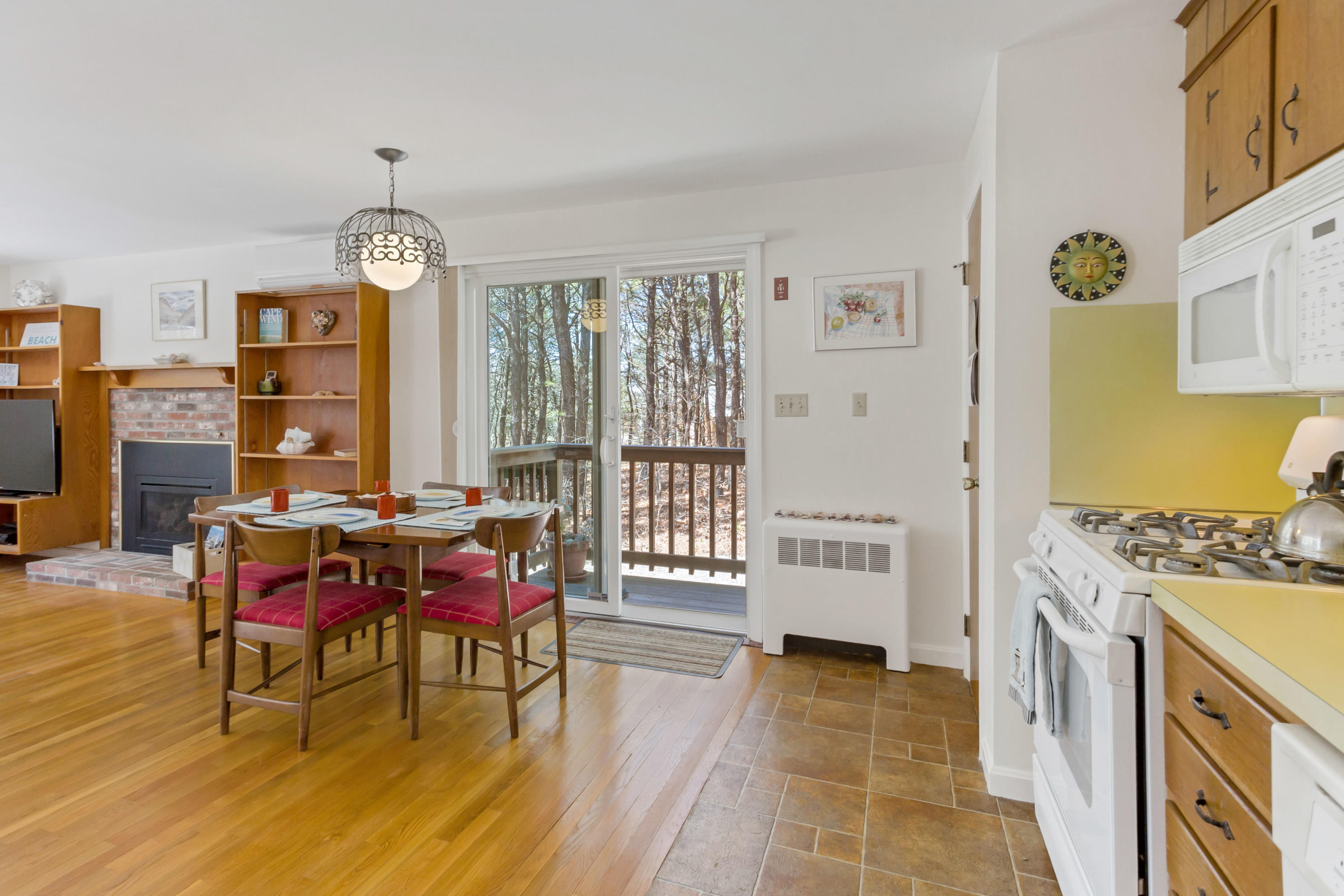 140 Salt Works Road Eastham, MA 02642 - Photo 18 of 49 a view of a dining room with furniture window and wooden floor