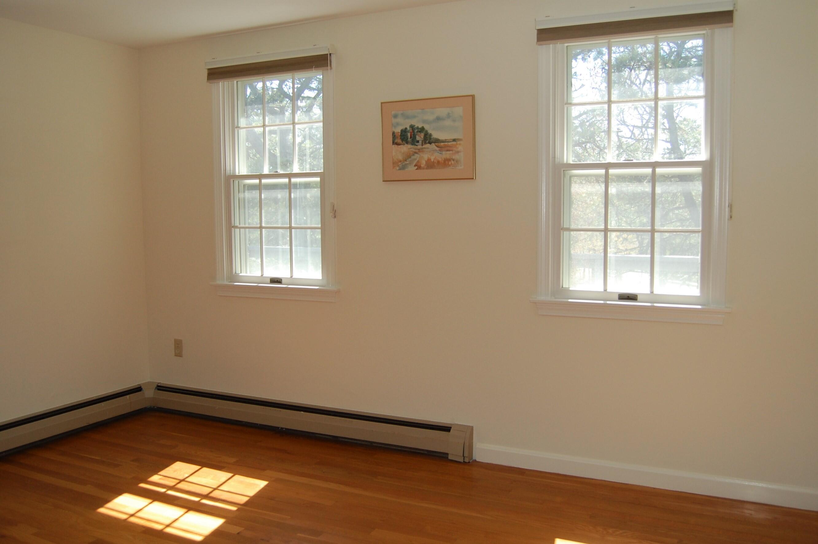 140 Salt Works Road Eastham, MA 02642 - Photo 22 of 49 wooden floor in an empty room with a window
