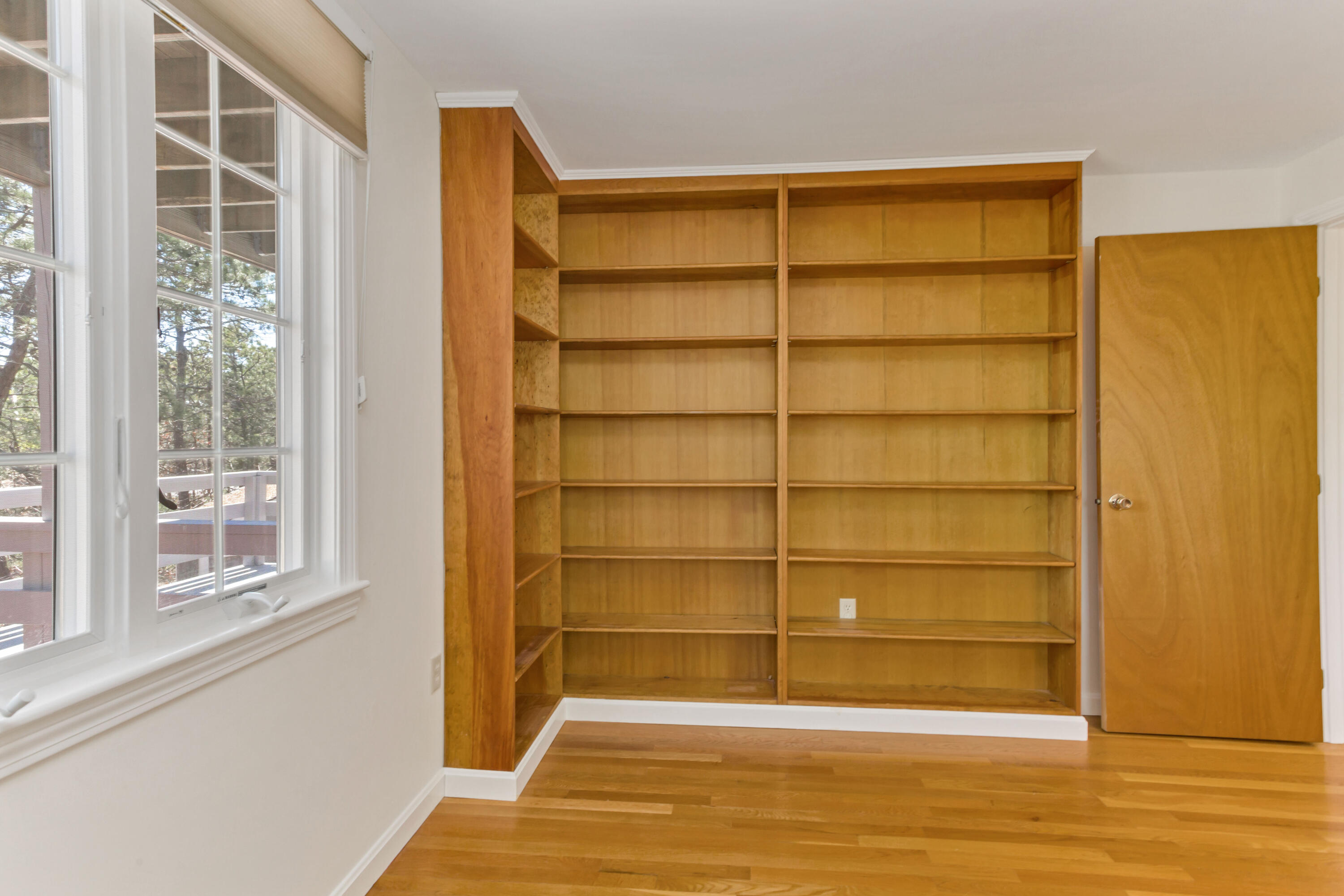 140 Salt Works Road Eastham, MA 02642 - Photo 26 of 49 a view of an empty room with wooden floor and a window