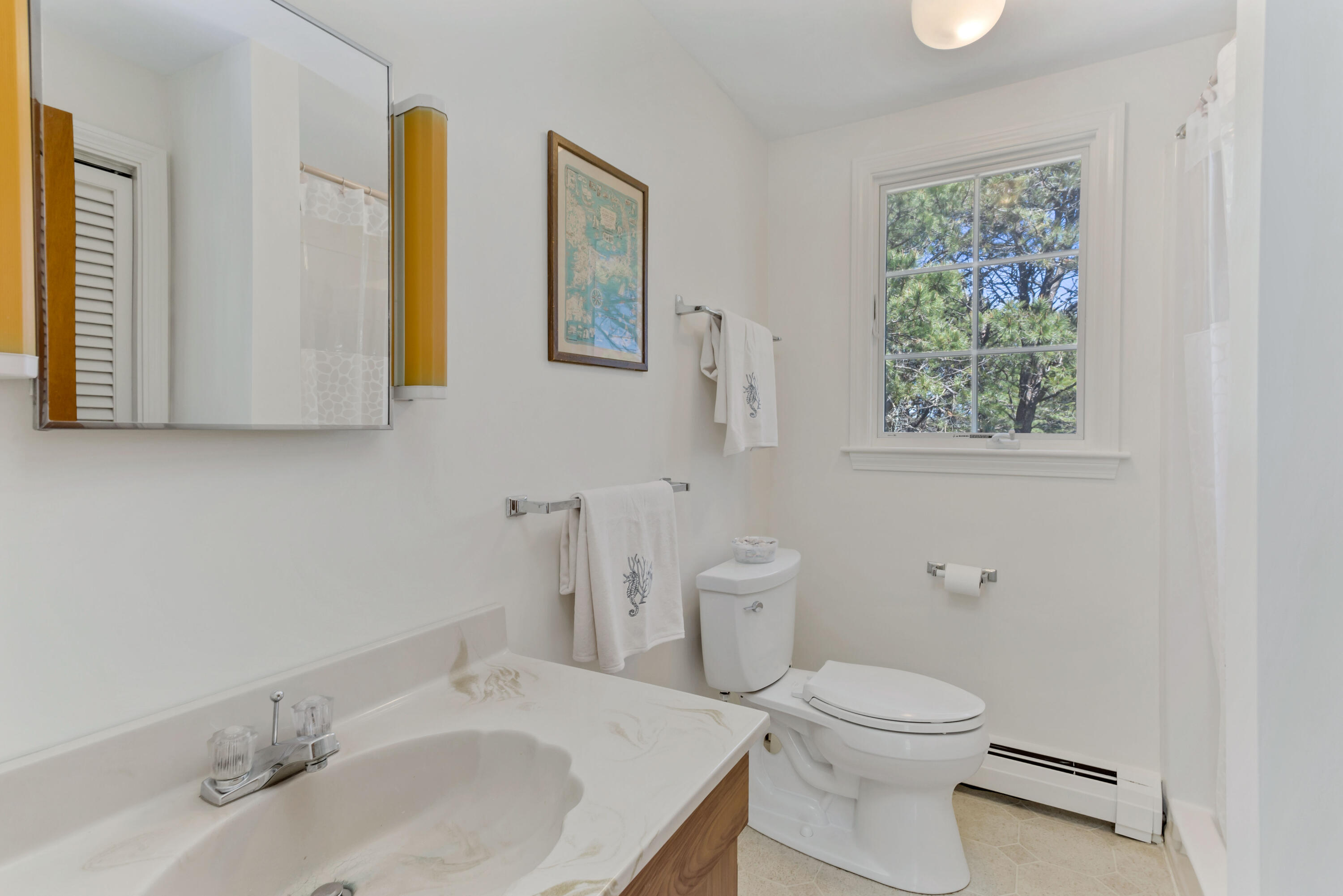 140 Salt Works Road Eastham, MA 02642 - Photo 27 of 49 a bathroom with a toilet a sink a mirror and a window
