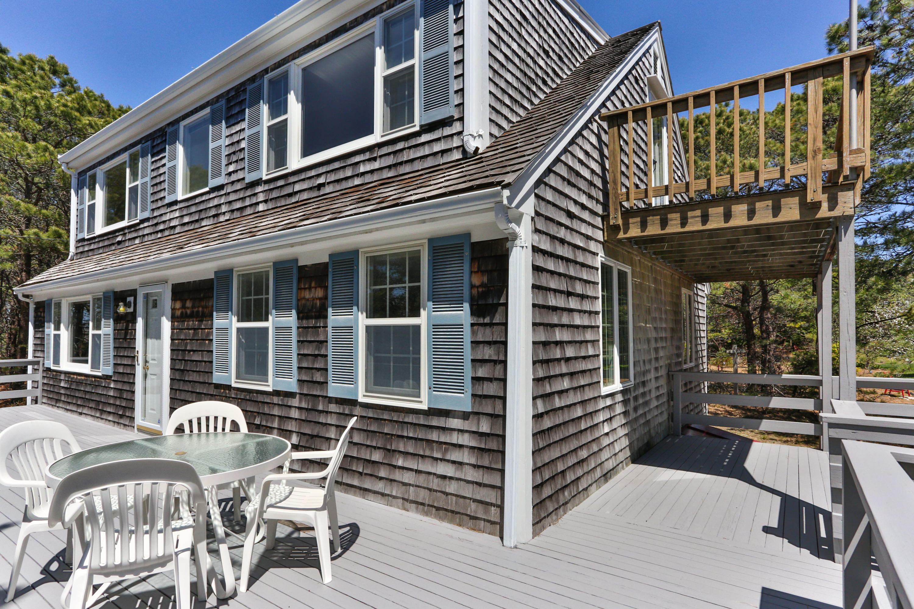 140 Salt Works Road Eastham, MA 02642 - Photo 4 of 49 a patio with table and chairs and potted plants