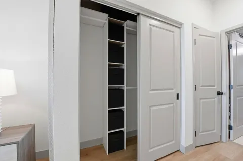 a spacious bathroom with a granite countertop sink a toilet and a mirror