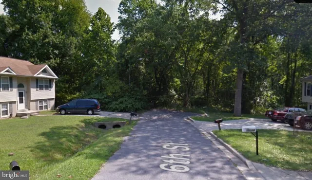 a view of swimming pool with a patio and a yard