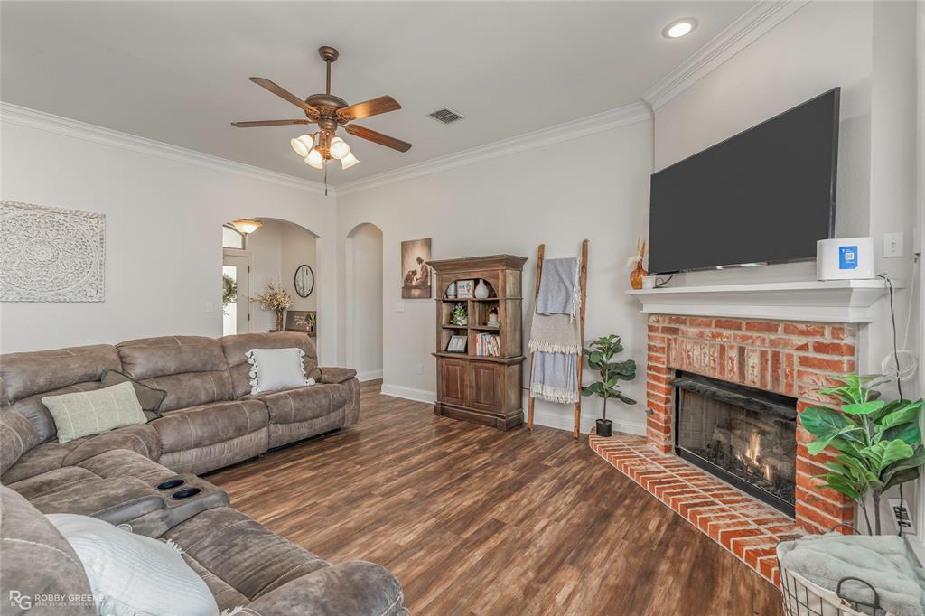 711 Reeds Reef Bossier City, LA 71112 - Photo 5 of 36 a living room with furniture a flat screen tv and a fireplace