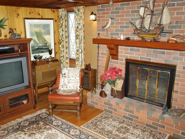 9 Arrowhead Farm Road Truro, MA 02666 - Photo 20 of 30 a living room with furniture and a fireplace