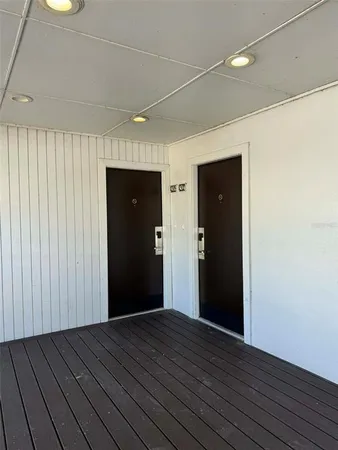 a view of hallway with wooden floor