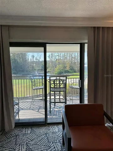 a view of a chairs and table in the balcony