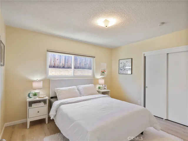 a bedroom with a bed and wall painting