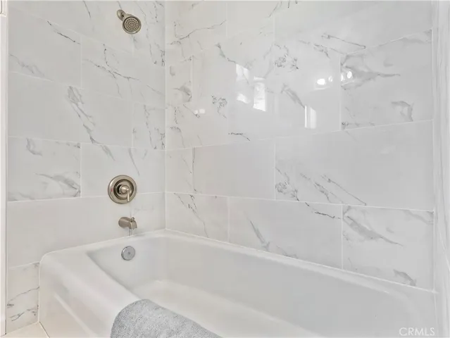 a bathroom with double vanity sinks and a mirror