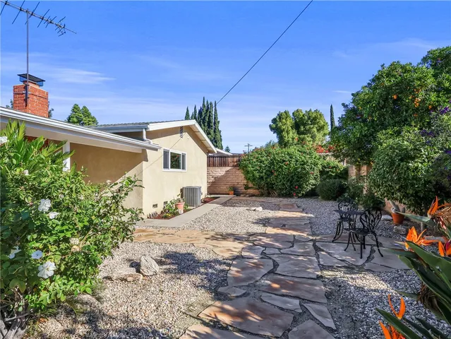 a view of a backyard with potted plants