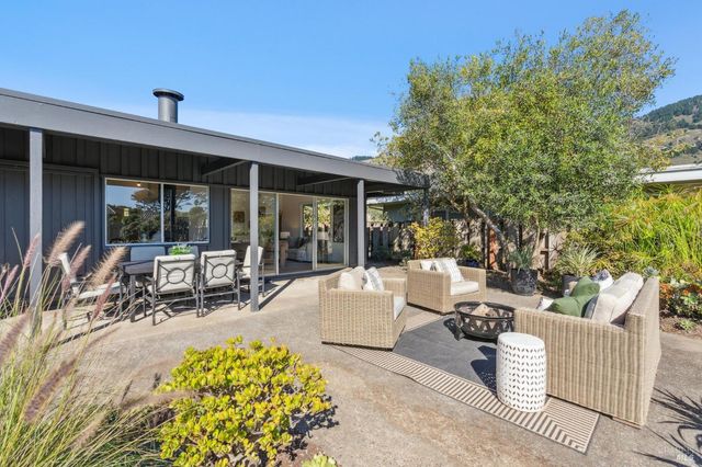 a view of a patio with table and chairs and potted plants