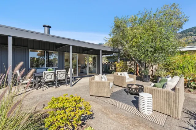 a view of a patio with table and chairs and potted plants