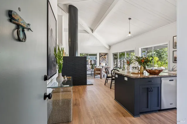 a view of kitchen with furniture and wooden floor