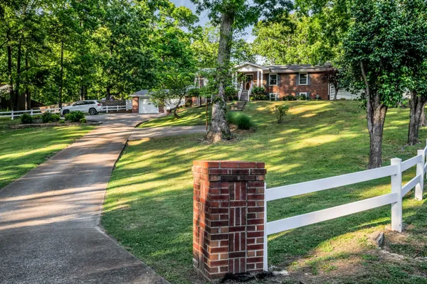 a view of a house with a backyard