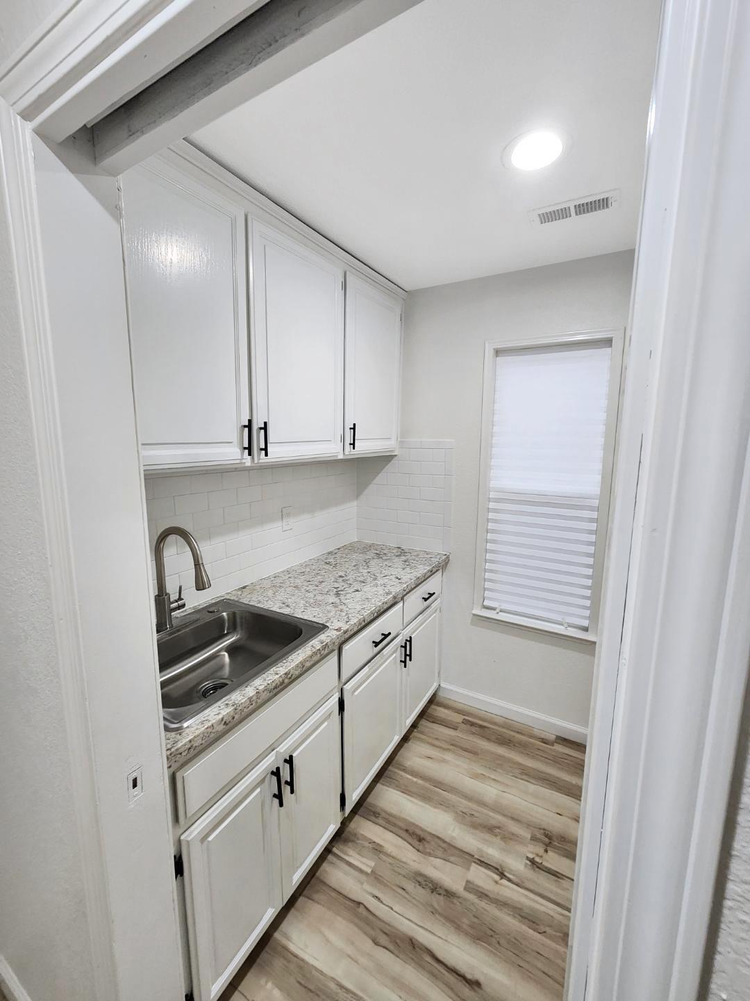 1963 Pontelli Court Stockton, CA 95207 - Photo 13 of 25 a kitchen with granite countertop white cabinets and stainless steel appliances