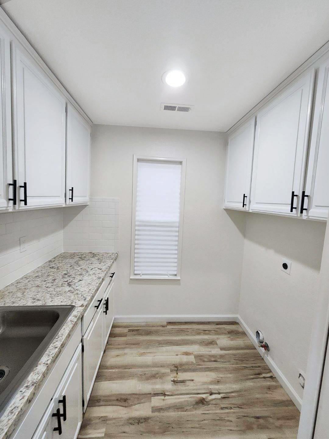 1963 Pontelli Court Stockton, CA 95207 - Photo 14 of 25 a kitchen with granite countertop white cabinets and white appliances