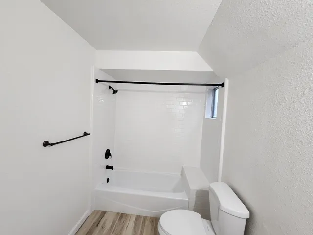 a bathroom with a toilet and a shower