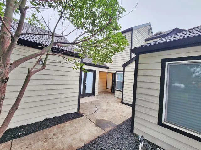 a view of a house with a door and wooden walls