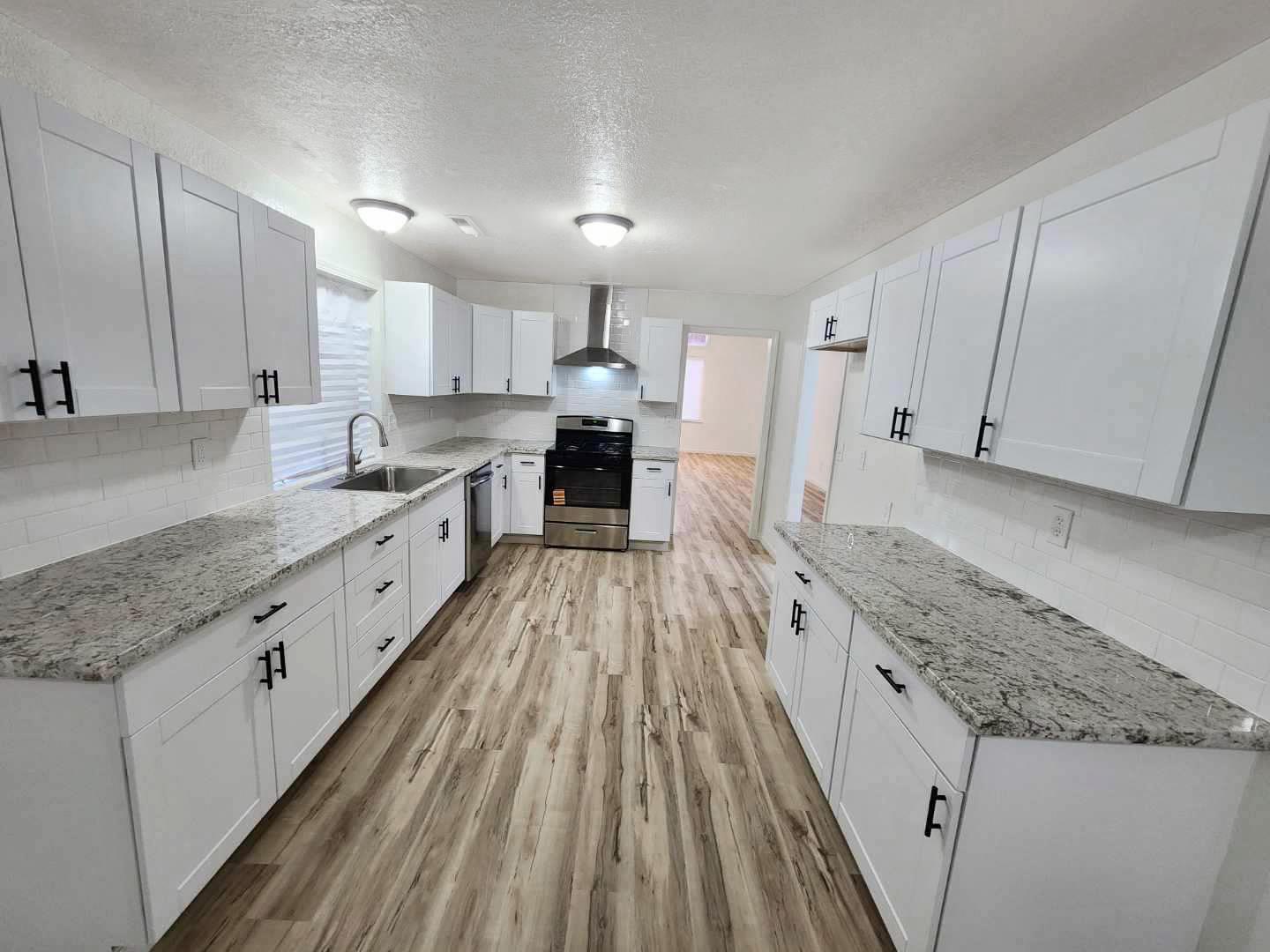 1963 Pontelli Court Stockton, CA 95207 - Photo 3 of 25 a large kitchen with granite countertop a large counter top stainless steel appliances and cabinets