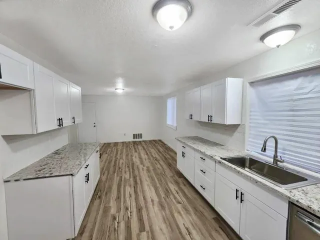 a kitchen with a sink and cabinets