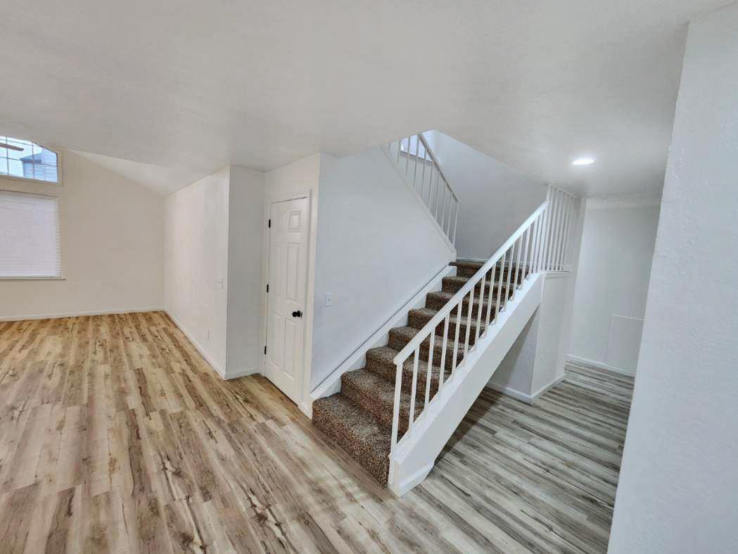 1963 Pontelli Court Stockton, CA 95207 - Photo 8 of 25 a view of a hallway with wooden floor and staircase