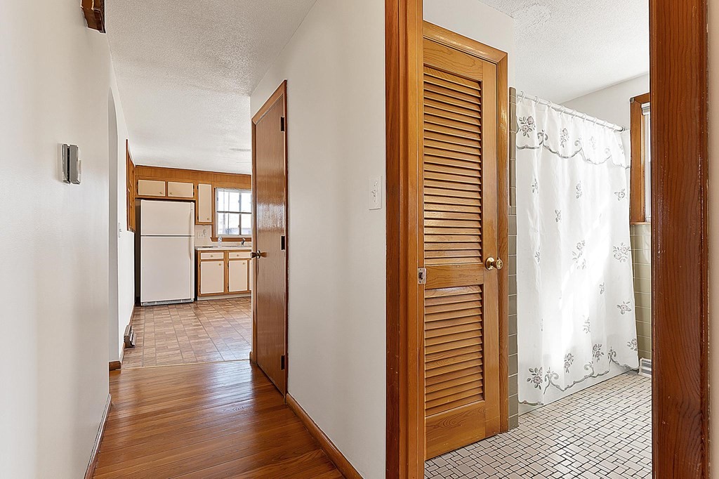 20 Davis Terrace Peabody, MA 01960 - Photo 17 of 25 a view of a hallway with wooden floor and a cabinet