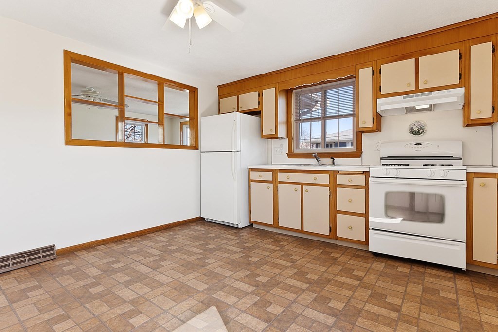 20 Davis Terrace Peabody, MA 01960 - Photo 7 of 25 a open kitchen with a stove top oven cabinets a sink and a window