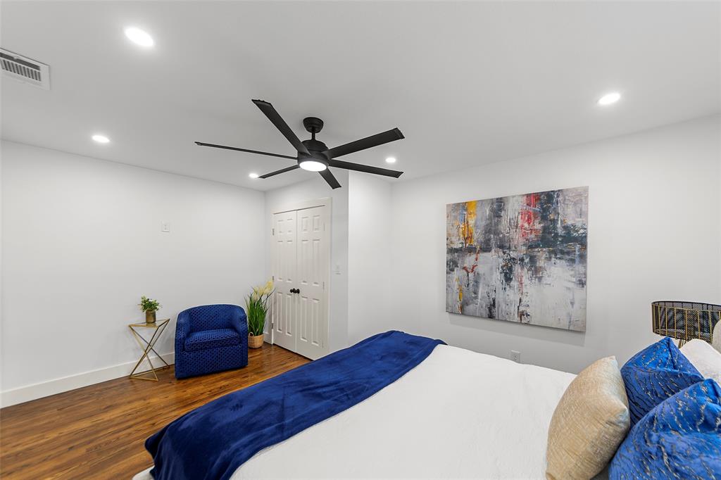 2945 Healey Drive Dallas, TX 75228 - Photo 14 of 38 a bedroom with a large bed and a painting on the wall
