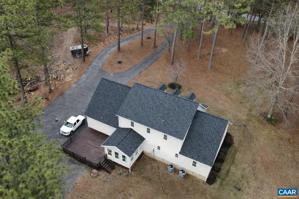 an aerial view of a house with a yard