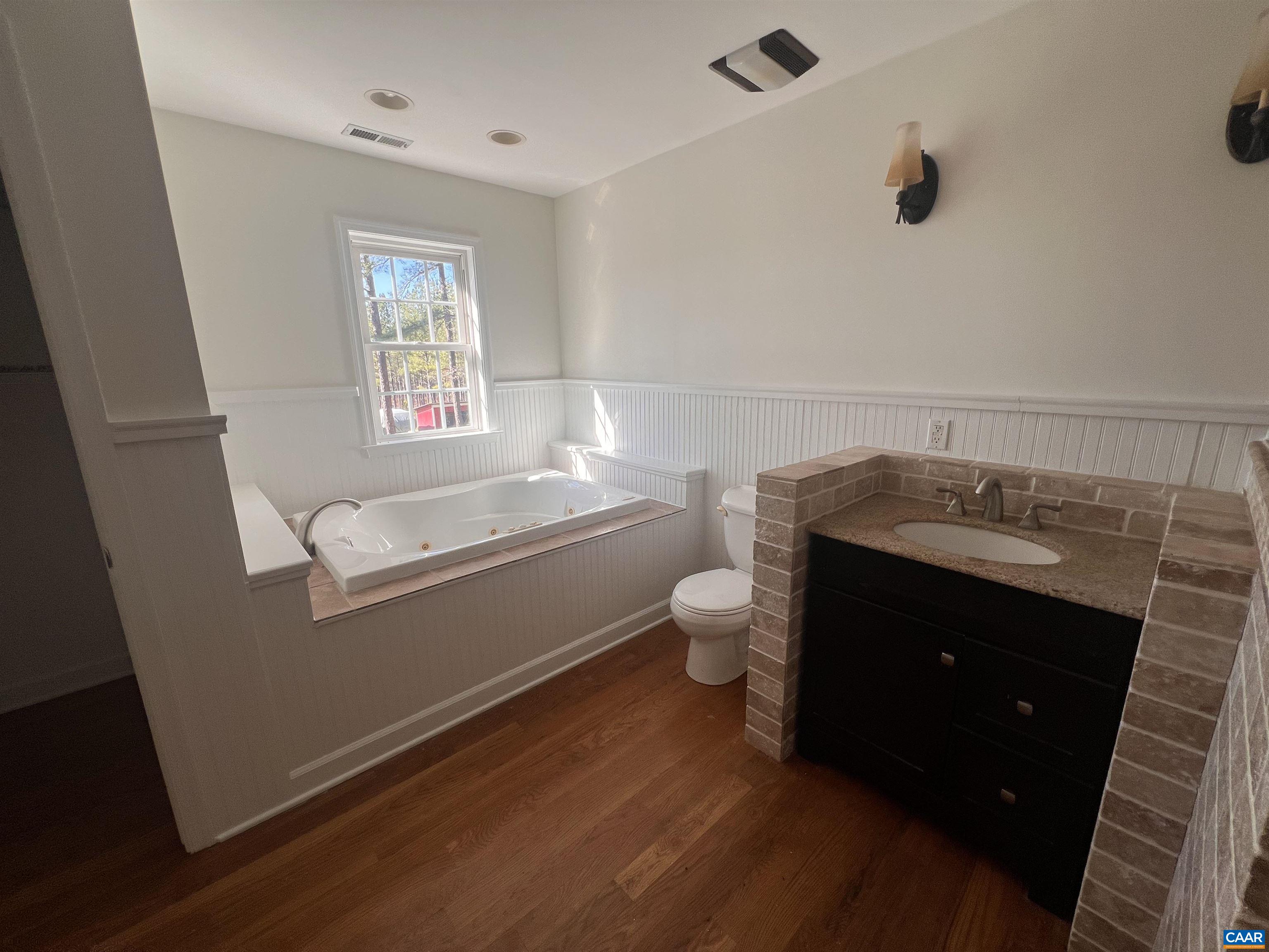 651 Kents Mill Road Louisa, VA 23093 - Photo 24 of 55 a bathroom with a granite countertop toilet sink and mirror