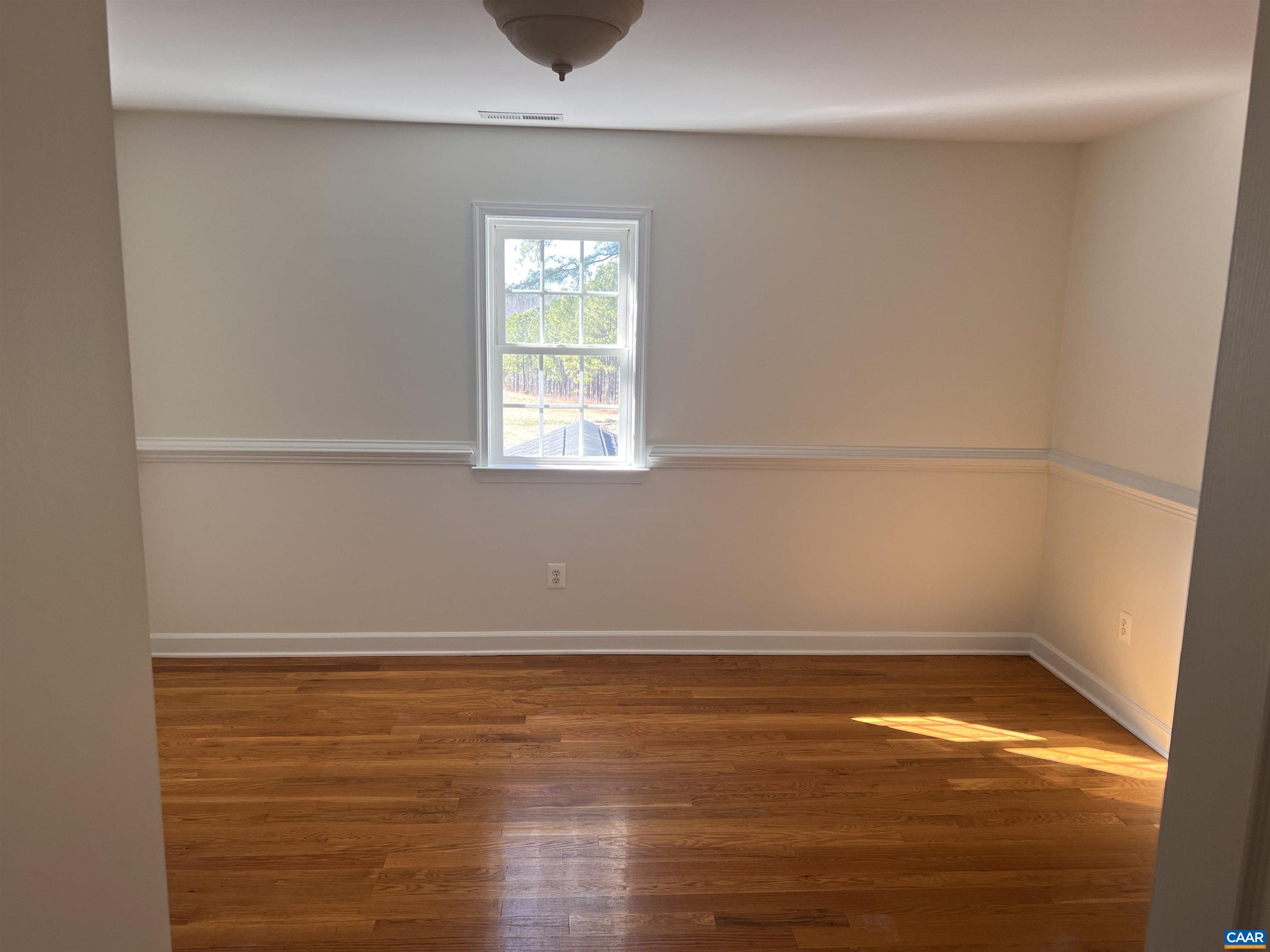 651 Kents Mill Road Louisa, VA 23093 - Photo 29 of 55 a view of an empty room with wooden floor and a window