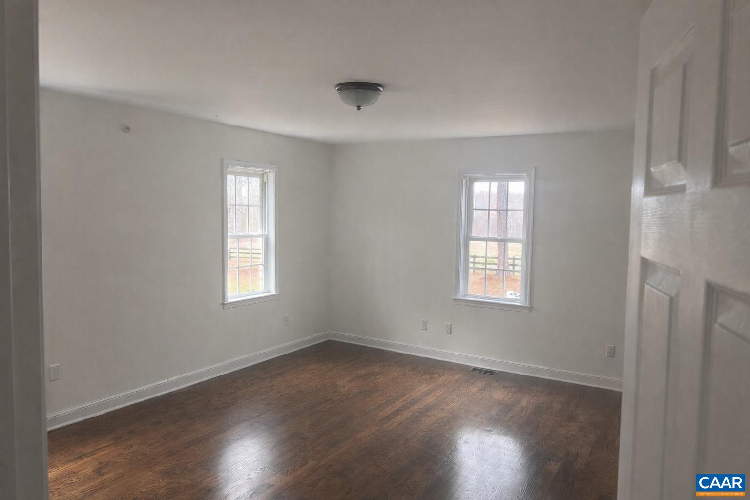 651 Kents Mill Road Louisa, VA 23093 - Photo 54 of 55 a view of an empty room with wooden floor and a window