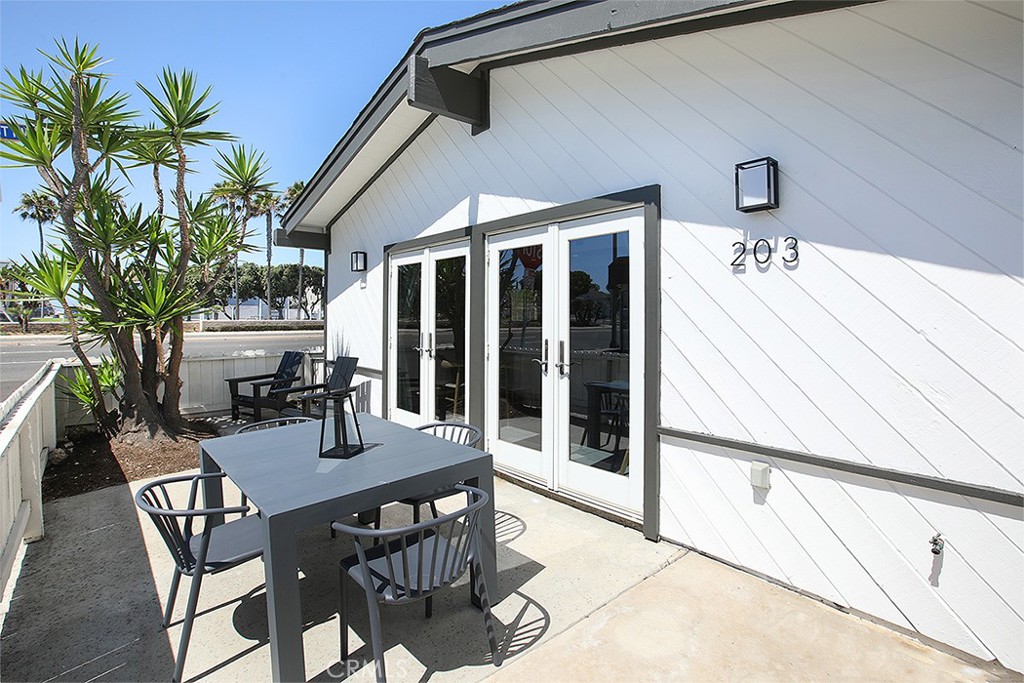 203 Cedar Street, Unit A & B Newport Beach, CA 92663 - Photo 13 of 32 a view of a patio with table and chairs and potted plants