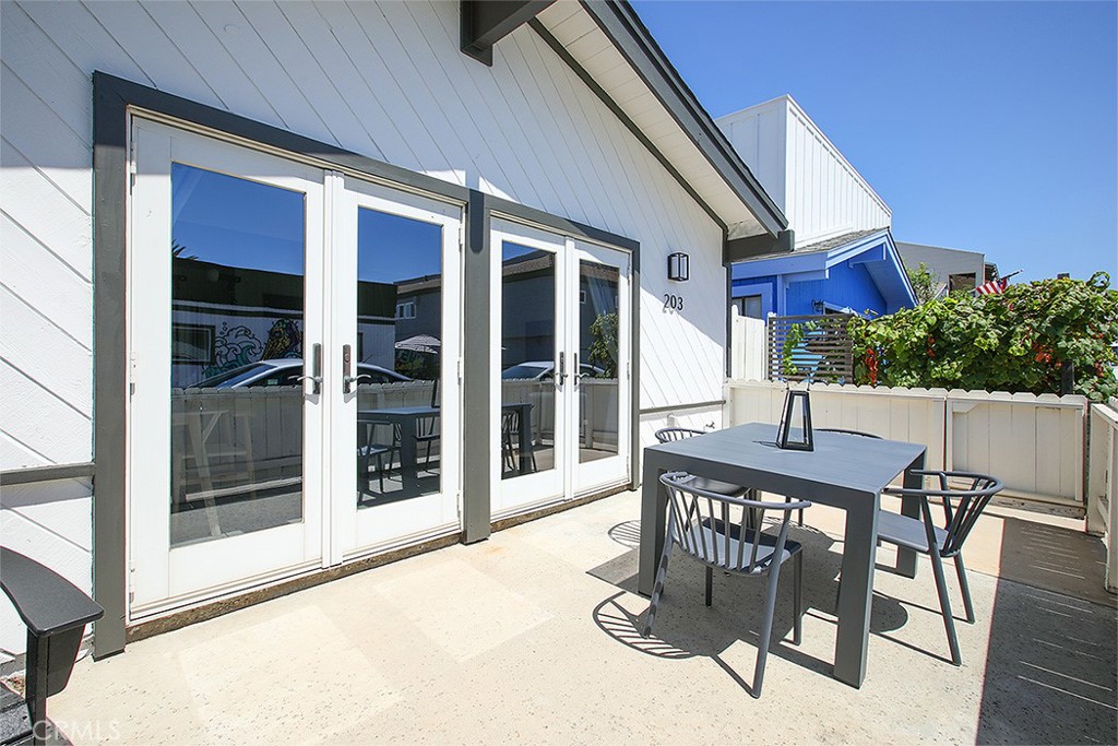 203 Cedar Street, Unit A & B Newport Beach, CA 92663 - Photo 15 of 32 a view of a patio with a table and chairs