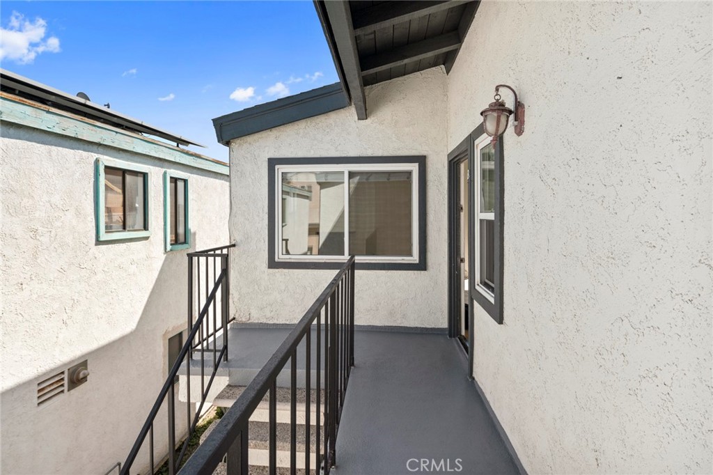 203 Cedar Street, Unit A & B Newport Beach, CA 92663 - Photo 16 of 32 a view of a hallway with wooden floor and staircase