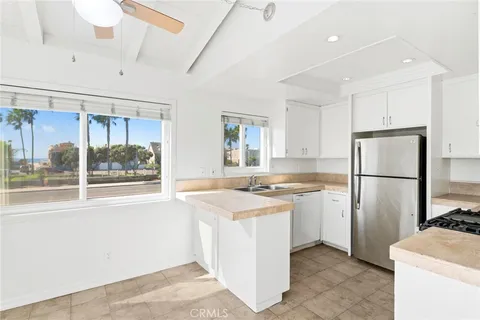 a view of a room with a window and a kitchen view