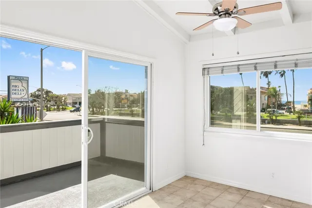 a view of an empty room with a fireplace and a window