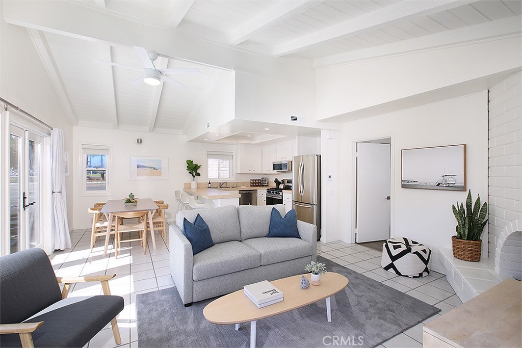 203 Cedar Street, Unit A & B Newport Beach, CA 92663 - Photo 2 of 32 a living room with furniture a rug and a dining table