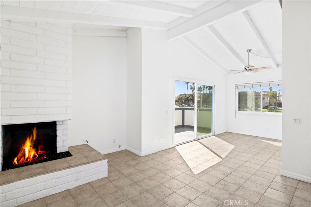 203 Cedar Street, Unit A & B Newport Beach, CA 92663 - Photo 21 of 32 a view of an empty room with a fireplace and a window