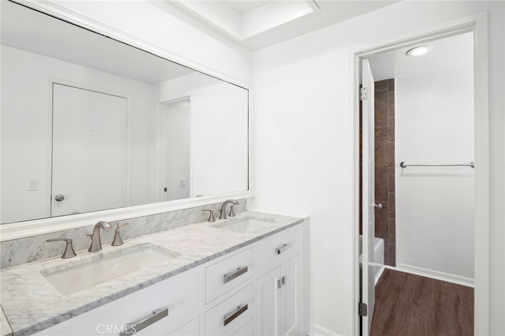 203 Cedar Street, Unit A & B Newport Beach, CA 92663 - Photo 23 of 32 a bathroom with a granite countertop sink and a mirror