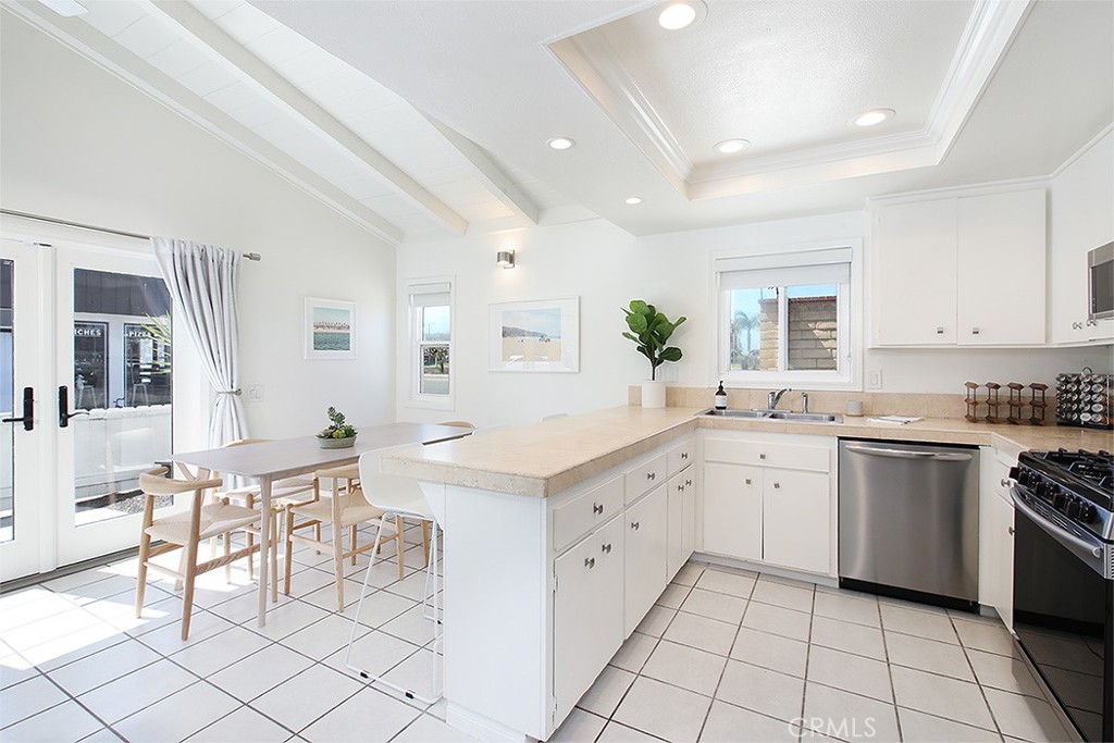 203 Cedar Street, Unit A & B Newport Beach, CA 92663 - Photo 4 of 32 a kitchen with white cabinets and appliances