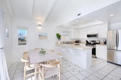 a kitchen with stainless steel appliances kitchen island granite countertop a refrigerator and a stove top oven