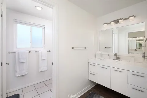 a spacious bathroom with a shower sink and mirror