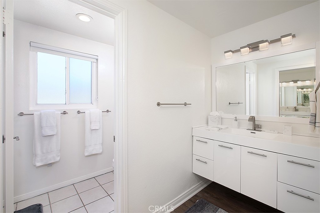 203 Cedar Street, Unit A & B Newport Beach, CA 92663 - Photo 9 of 32 a spacious bathroom with a shower sink and mirror