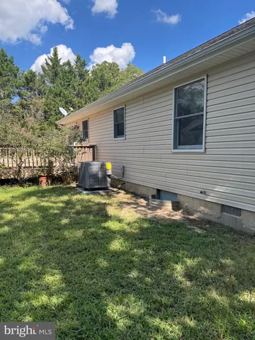 a backyard of a house with garden and outdoor seating