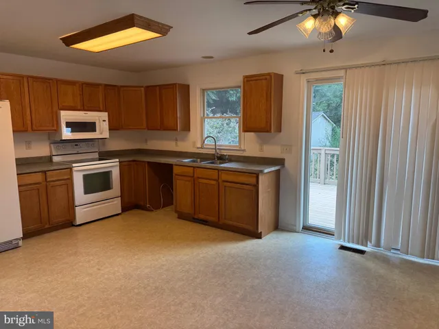 a kitchen with a sink stove and microwave
