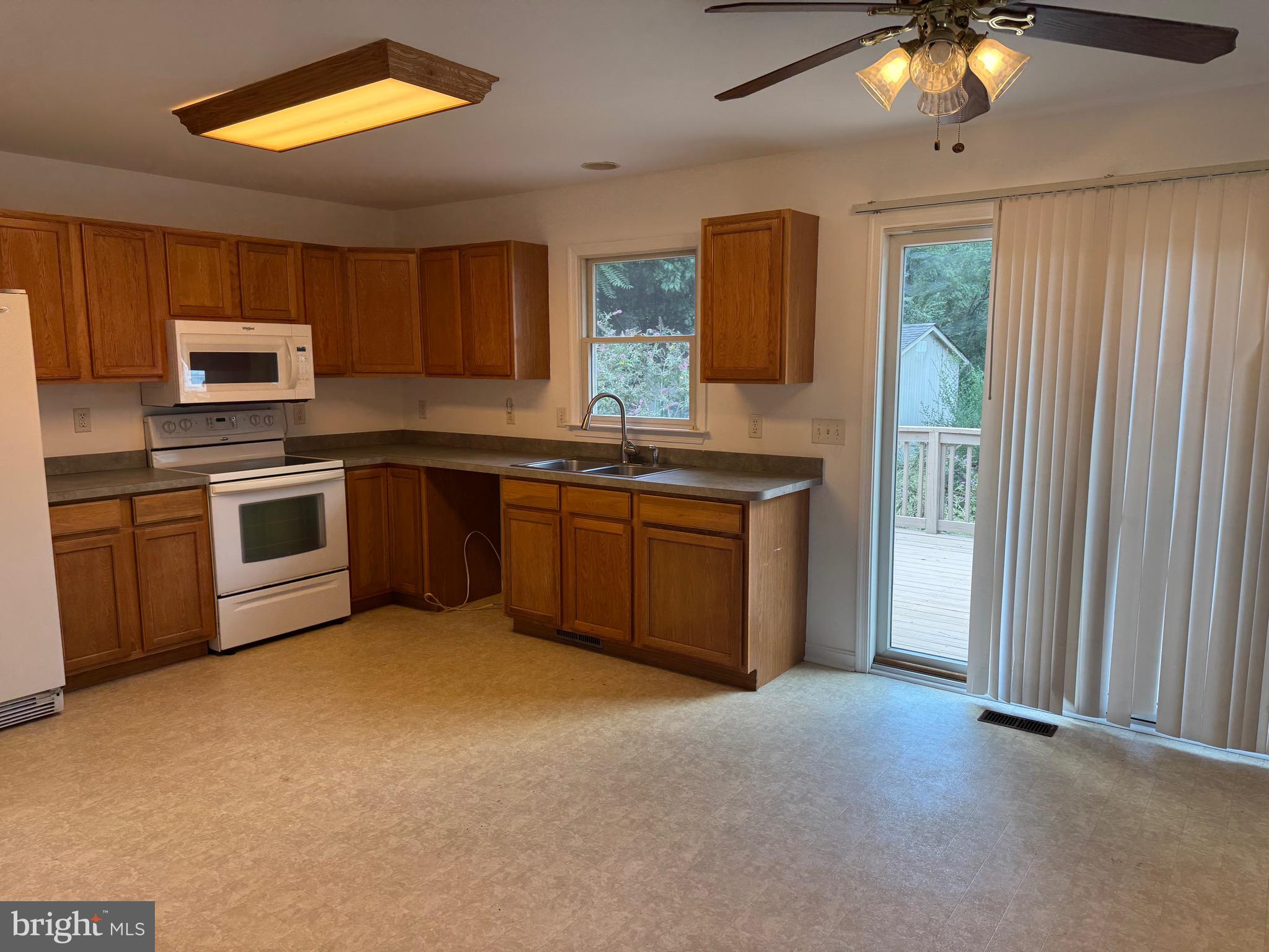 113 Boyce Mill Road Greensboro, MD 21639 - Photo 4 of 23 a kitchen with a sink stove and microwave