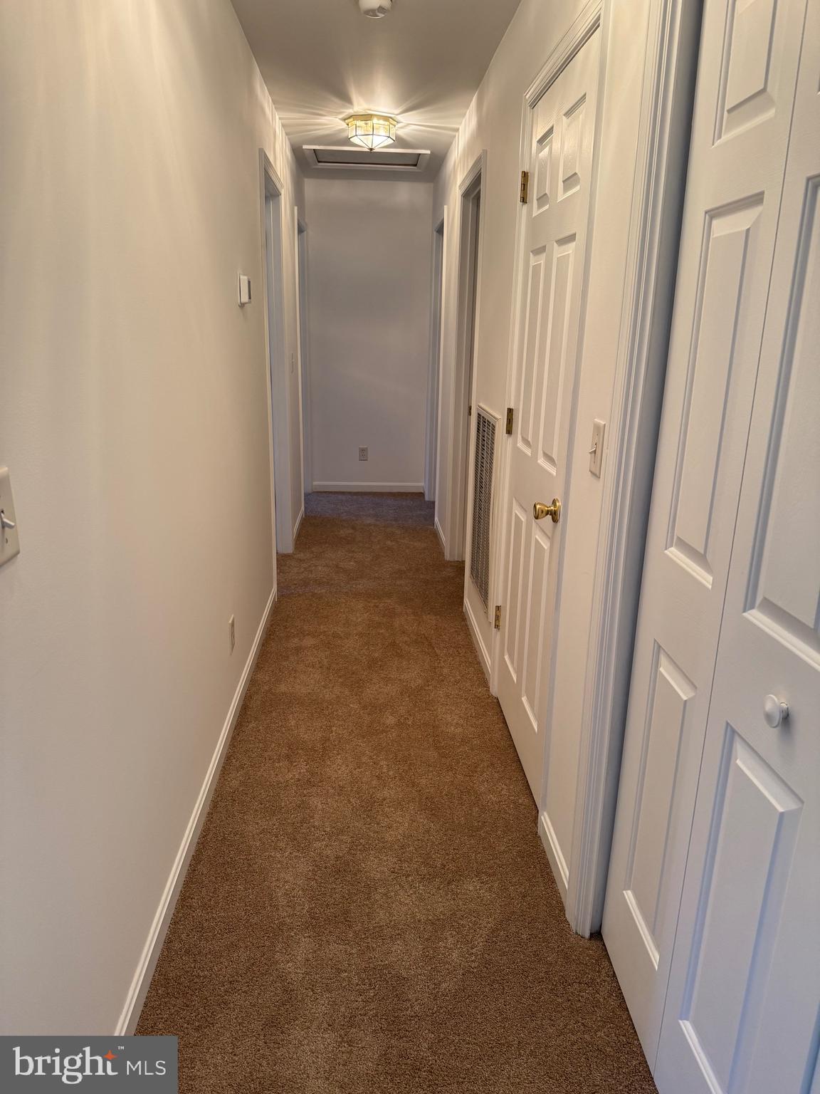 113 Boyce Mill Road Greensboro, MD 21639 - Photo 5 of 23 a view of a hallway with wooden floor and staircase