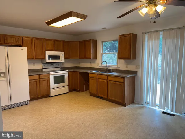 a kitchen with stainless steel appliances granite countertop a stove sink and refrigerator